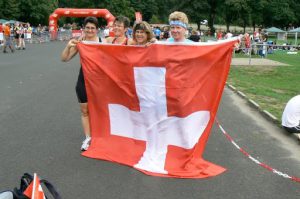 Athletes (women runners from Team Switzerland) gather outside to form